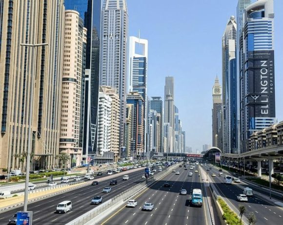 Dubai skyline along Sheikh Zayed Road showing multi-lane traffic, modern skyscrapers, and urban transport infrastructure in the UAE.