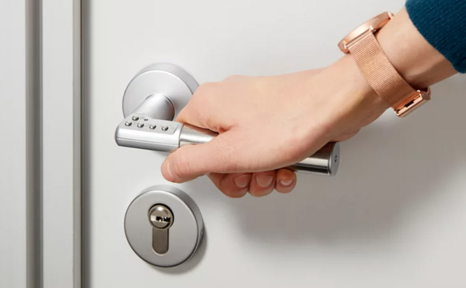 ASSA ABLOY Code Handle standalone digital PIN door handle installed on an office door.