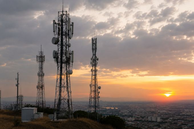 Telecommunications towers overlooking an urban area as part of national mobile communications infrastructure.