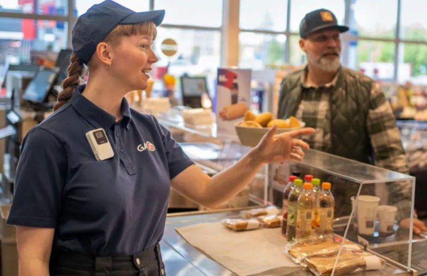Axis W111 body worn camera worn by a retail employee assisting a customer