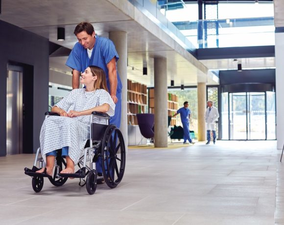Healthcare staff using an integrated IP public address and emergency communication system in a modern hospital