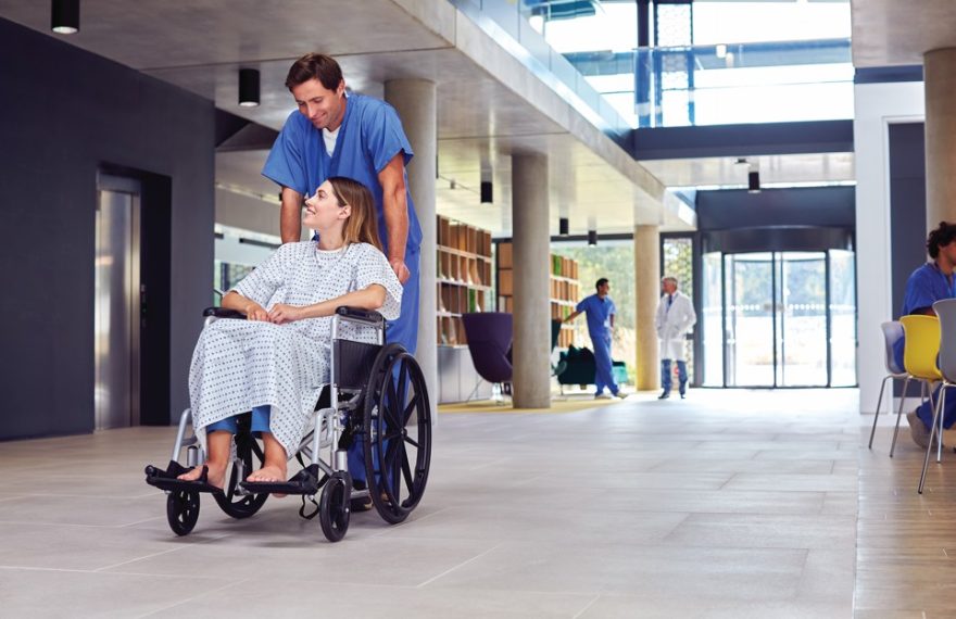 Healthcare staff using an integrated IP public address and emergency communication system in a modern hospital