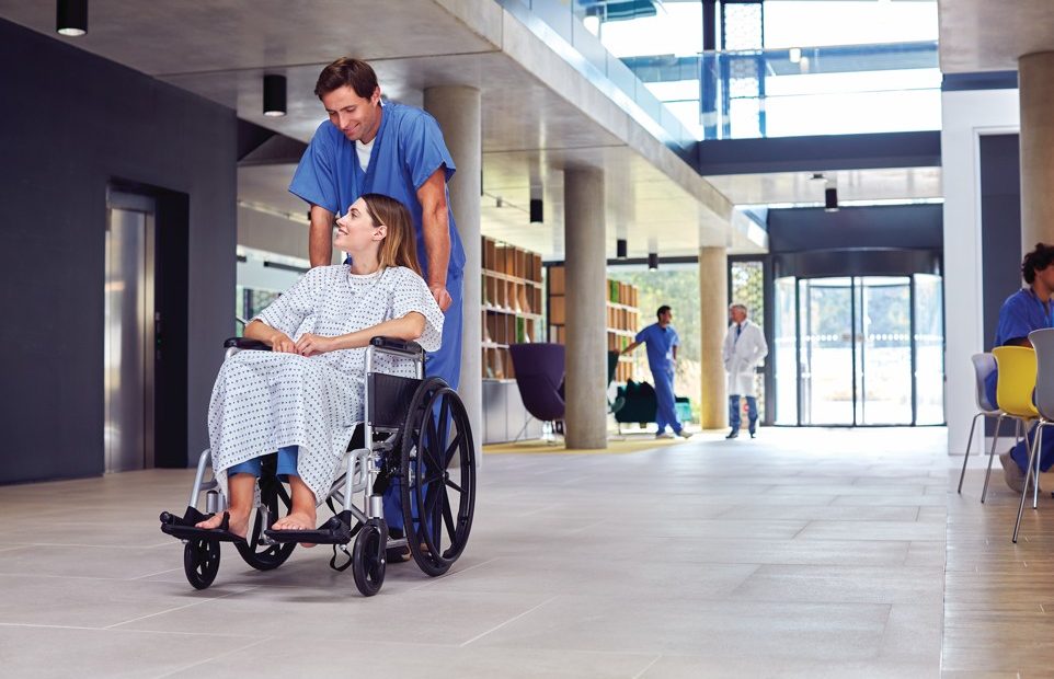 Healthcare staff using an integrated IP public address and emergency communication system in a modern hospital