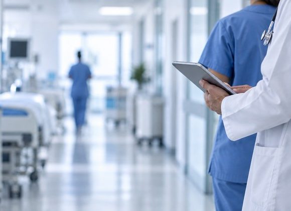 Healthcare staff using a tablet in a hospital environment illustrating Cleopatra Hospitals cybersecurity operations