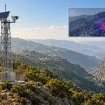 Solar-powered surveillance tower with thermal camera monitoring forest fire risks in Saudi Arabia's Al-Baha region